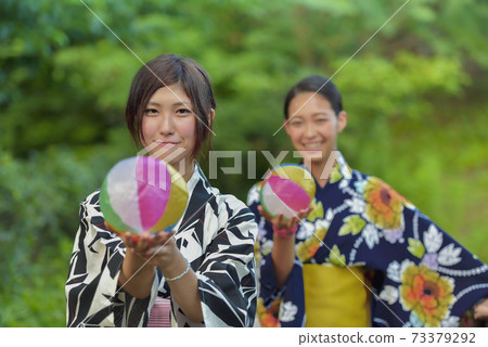 Two women in a yukata with a paper balloon Two women in a yukata with a paper balloon 73379292