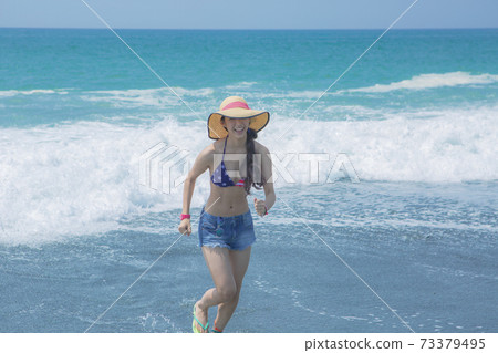 Swimsuit woman running at the beach Swimsuit woman running at the beach 73379495