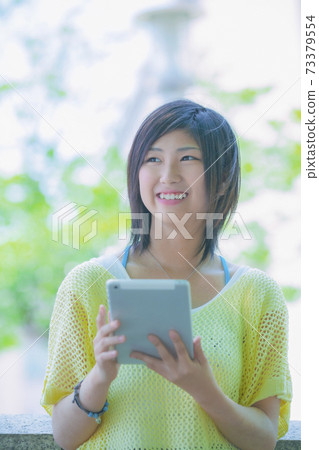 A woman with a tablet PC A woman with a tablet PC 73379554