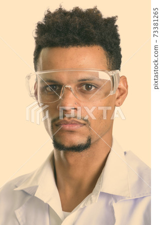 Face of young African man doctor wearing protective glasses 73381265