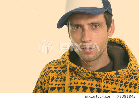 Close up of young handsome man wearing cap 73381842