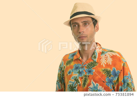 Studio shot of young handsome tourist man thinking ready for vacation Studio shot of young handsome tourist man thinking ready for vacation 73381894