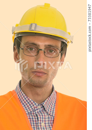 Face of young handsome man construction worker wearing eyeglasses Face of young handsome man construction worker wearing eyeglasses 73381947