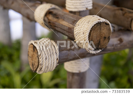 Wooden logs tied with coarse hemp rope 73383539