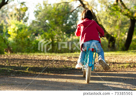 Kindergarten children riding a bicycle 73385501