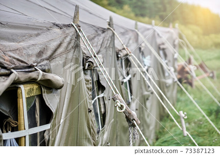 Big military field tent with windows and a stove. Tent window close-up Big military field tent with windows and a stove. Tent window close-up 73387123