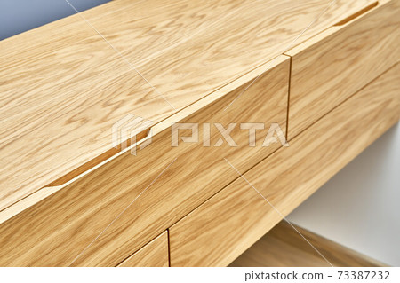 Floating wooden cabinet of finger pull design closeup 73387232