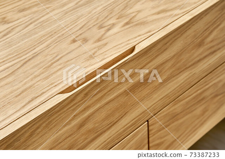 Floating wooden cabinet of finger pull design closeup 73387233