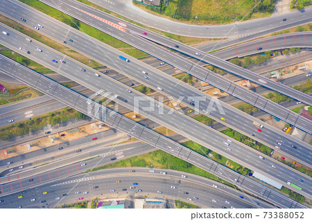 Aerial view of cars driving on highway or moterway. Overpass bridge street roads in connection network of architecture concept. Top view. Urban city, Bangkok, Thailand. Aerial view of cars driving on highway or moterway. Overpass bridge street roads in connection network of architecture concept. Top view. Urban city, Bangkok, Thailand. 73388052