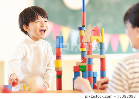 Little boy playing with blocks Little boy playing with blocks 73388098