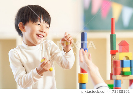 Little boy playing with blocks 73388101