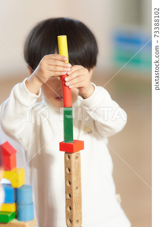 Little boy playing with blocks 73388102