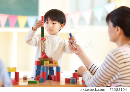 Little boy playing with blocks Little boy playing with blocks 73388104
