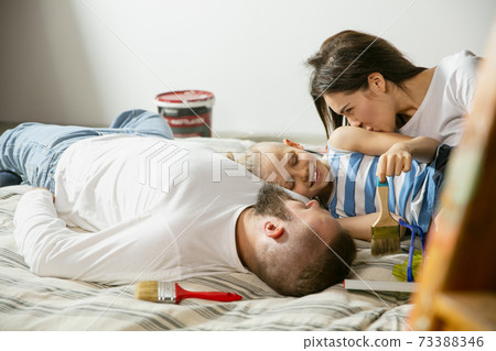 Young family doing apartment repair together themselves. Mother, father and son doing home makeover or renovation 73388346