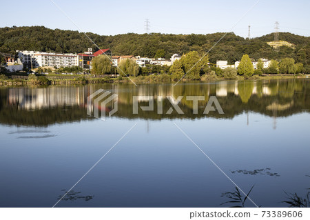 Lake reflection with buildings Lake reflection with buildings 73389606