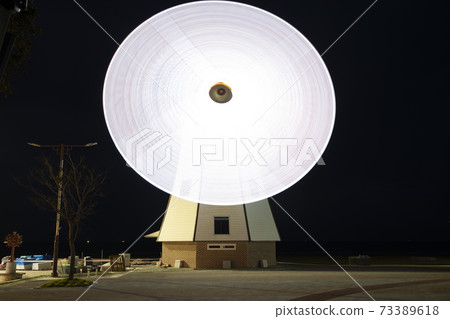 Windmill wings rotating at night Windmill wings rotating at night 73389618
