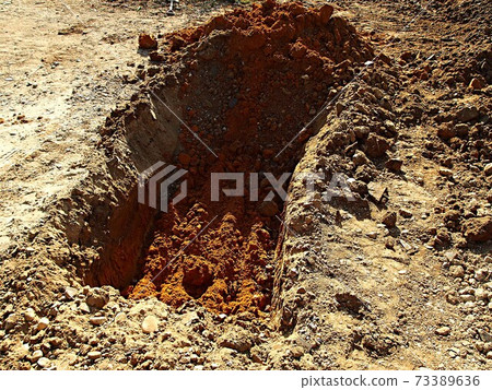 Hole dug with a power shovel Hole dug with a power shovel 73389636