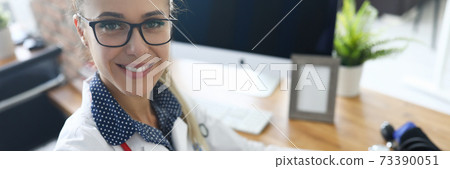 Woman working in medical office 73390051