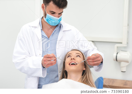 Woman in stomatology clinic with male dentist Woman in stomatology clinic with male dentist 73390180