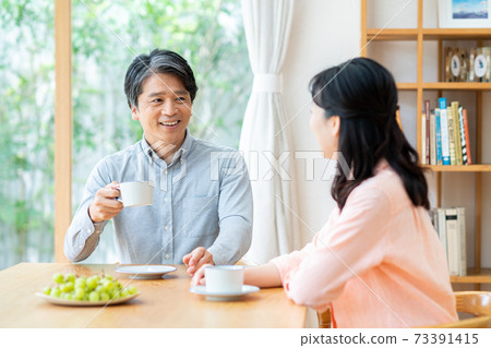 Middle-aged couple relaxing at home Middle-aged couple relaxing at home 73391415