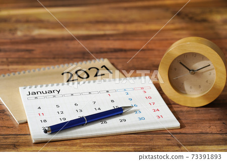 Calendar, schedule and clock placed on a wood grain desk 73391893