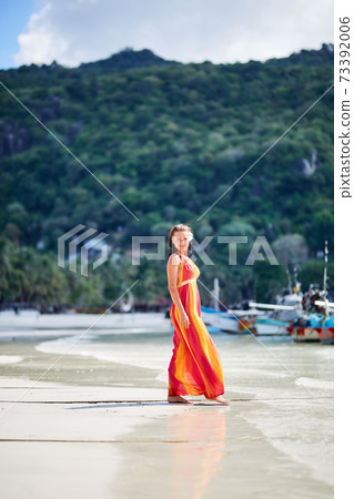 Sexy girl i long dress posing on the tropical beach Sexy girl i long dress posing on the tropical beach 73392006