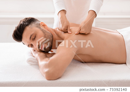 Middle aged bearded man attending modern male spa 73392140