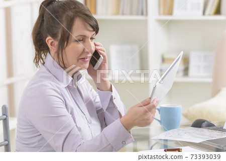 Woman works remotely from home Woman works remotely from home 73393039