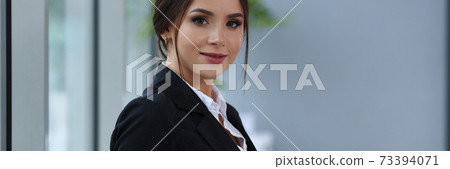 Beautiful smiling clerk girl wearing suit hold notebook 73394071