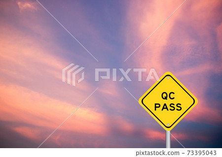 Yellow transportation sign with word QC (Quality Control) pass on violet sky background Yellow transportation sign with word QC (Quality Control) pass on violet sky background 73395043