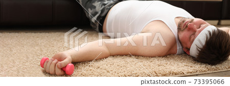 Young man sleepingon floor fitness at home Young man sleepingon floor fitness at home 73395066