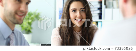 Smiling three colleagues during meeting in office Smiling three colleagues during meeting in office 73395086