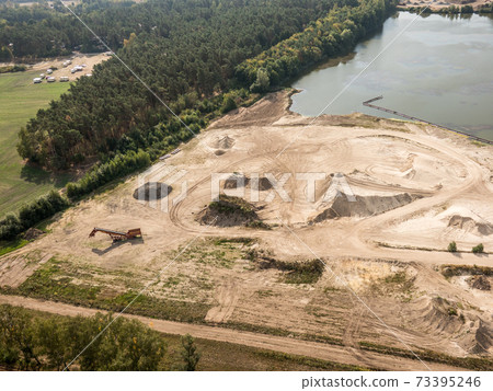 Vertical aerial view of a sand quarry in the heath Vertical aerial view of a sand quarry in the heath 73395246