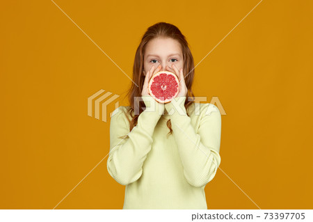 cute little child girl holding fresh juicy grapefruit cute little child girl holding fresh juicy grapefruit 73397705