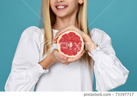 cute little child girl holding fresh juicy grapefruit cute little child girl holding fresh juicy grapefruit 73397717