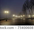 Foggy embankment lit by lanterns 73400608