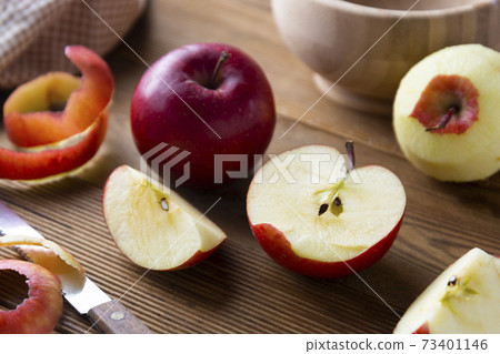 Red apples slices on wooden rustic table. 73401146