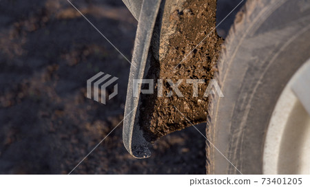 dirty car mudguard on the rear wheel splashed with a wet swamp close-up, traveling along a rural field road to a suv 4x4, nobody. dirty car mudguard on the rear wheel splashed with a wet swamp close-up, traveling along a rural field road to a suv 4x4, nobody. 73401205