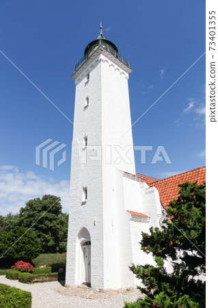 Church and lighthouse together in Tuno island, Denmark  73401355