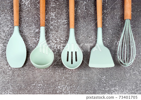 Kitchen utensils, home kitchen tools, mint rubber accessories on dark background. Restaurant, cooking, culinary, kitchen theme. Silicone spatulas and brushes, free space for text Kitchen utensils, home kitchen tools, mint rubber accessories on dark background. Restaurant, cooking, culinary, kitchen theme. Silicone spatulas and brushes, free space for text 73401705