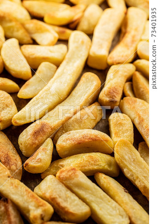 Big french fries. Fried potato chips. 73401935