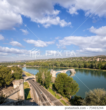 Avignon, famous bridge with Rhone river against blue sky in Provence, France 73403244