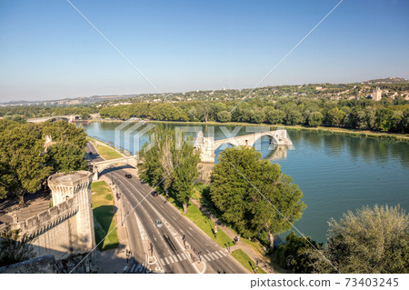 Avignon, famous bridge with Rhone river against blue sky in Provence, France 73403245