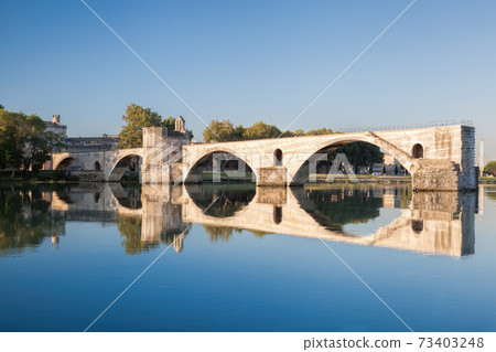 Avignon, famous bridge with Rhone river against blue sky in Provence, France 73403248