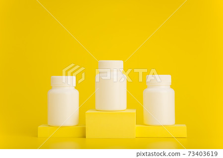 White medication bottles on yellow winner - Stock Photo