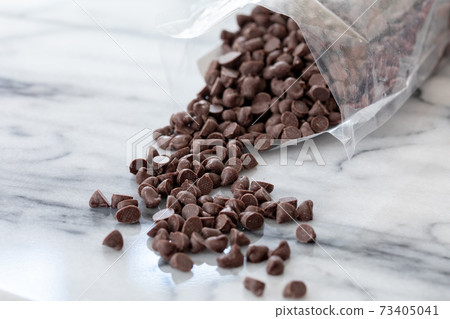 Chocolate chips taken out of the bag and studded with marble Chocolate chips taken out of the bag and studded with marble 73405041