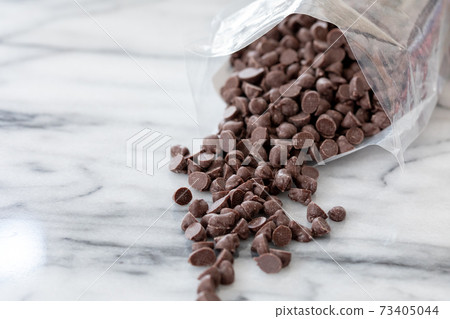 Chocolate chips taken out of the bag and studded with marble Chocolate chips taken out of the bag and studded with marble 73405044