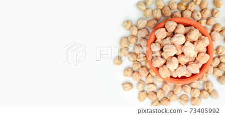 Uncooked dried chickpeas on white background with copy space	 73405992