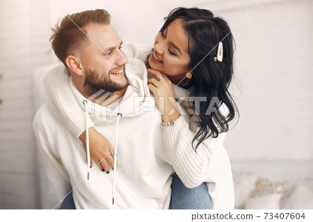 Beautiful couple spend time in a bedroom Beautiful couple spend time in a bedroom 73407604