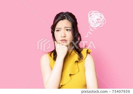 A woman with a troubled face is disappointed A woman with a troubled face is disappointed 73407939